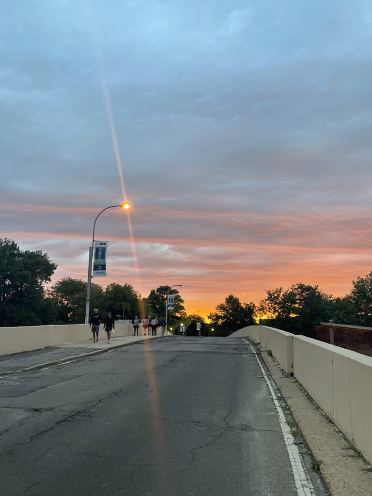 Picture of a streetlight and concrete walkway at sunset. 