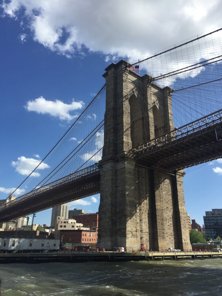Picture of the Brooklyn Bridge taken from a boat. 