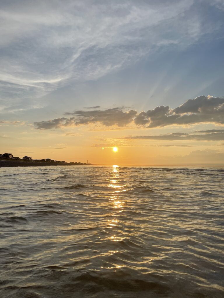 Picture of the sunset and sky reflecting off the ocean water. 
